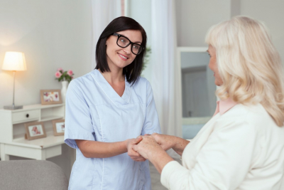 caregiver and senior woman are smiling